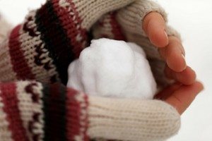 small snow ball in gloved hands