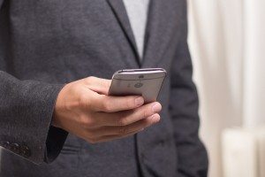 young professional holding a smartphone