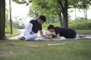 couple in the park with their baby