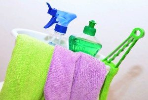 a bucket with towels, soap, and other cleaning supplies 