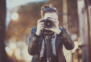 photograph of a woman taking a photo headon