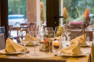 A set table at a fancy restaurant set up with wine glasses.